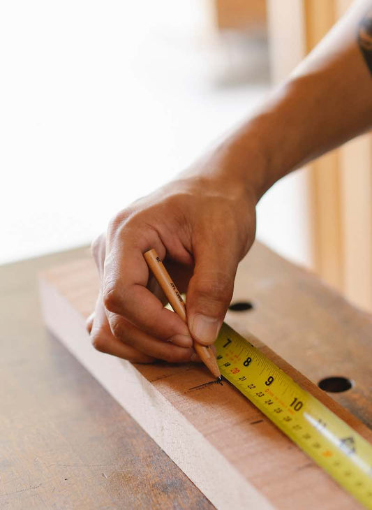Man Measuring in a Maker Space